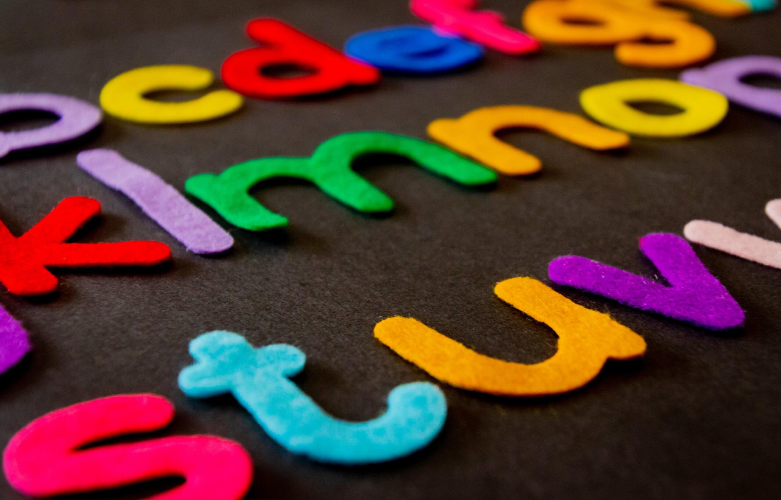 Felt letters of the alphabet on black background