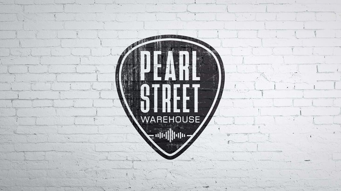 Pearl Street Warehouse logo on a white brick wall