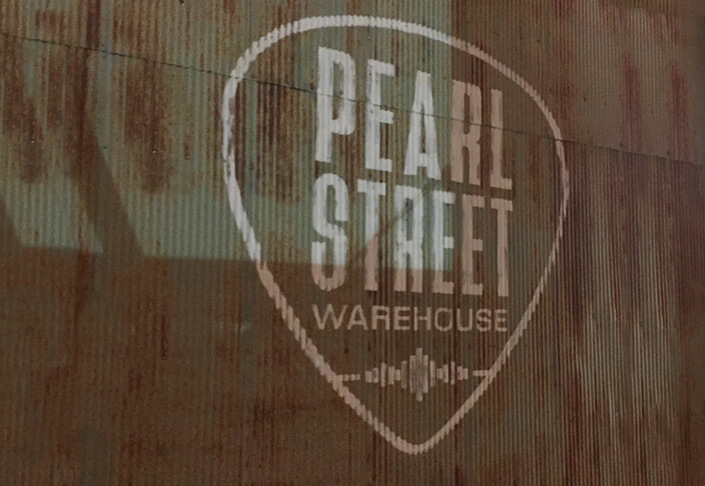 Pearl Street Warehouse logo on the side of a building