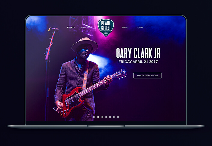 Home page of Pearl Street Warehouse website show on a computer screen.