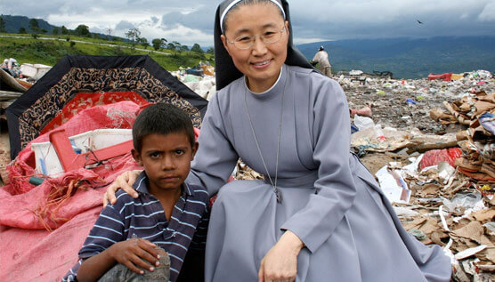 Sister and young boy at one of WVC's international villages