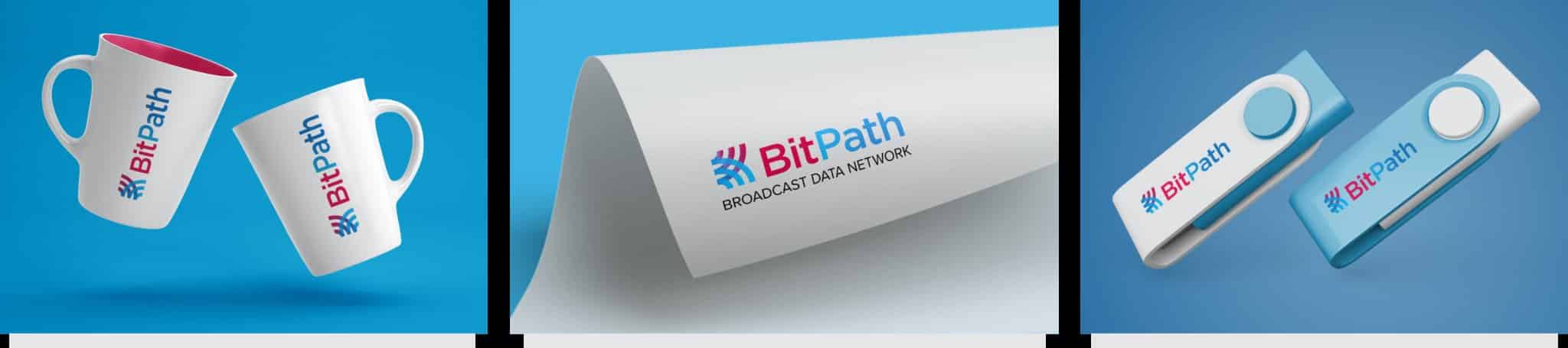 BitPath branded merchandise including mugs, letterhead, and USB drives