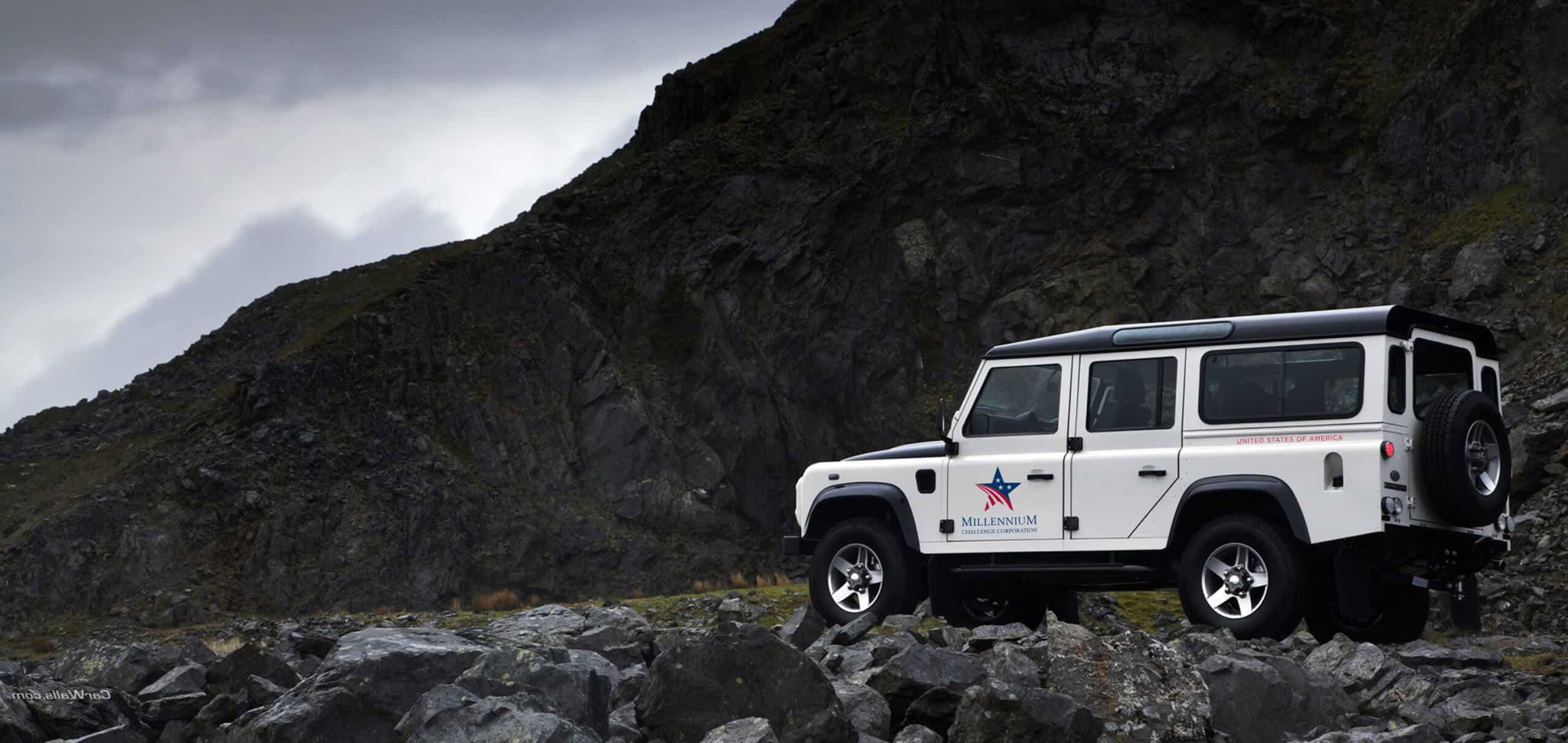 Millennium Challenge Corporation branded truck with MCC logo marking in the field